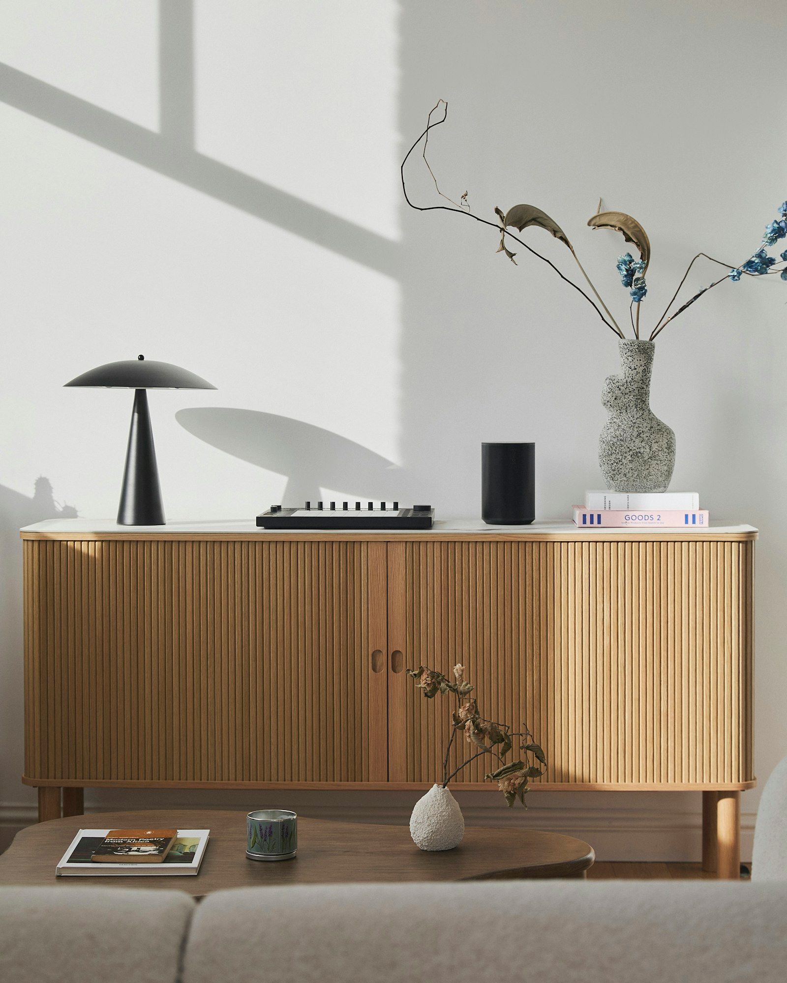 Aparador de madera con lámpara, jarrón y objetos decorativos